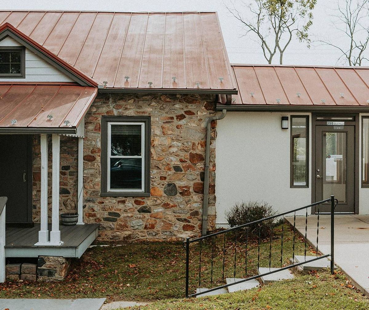 The Willow Tree Mental Health office in Exton, Pennsylvania &ndash; a stone farmhouse with a copper roof and a ramped entrance.
